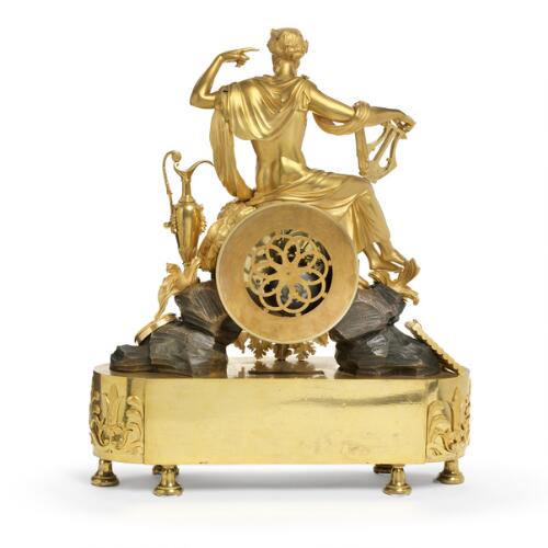 A French Empire gilt and patinated bronze figural mantel clock