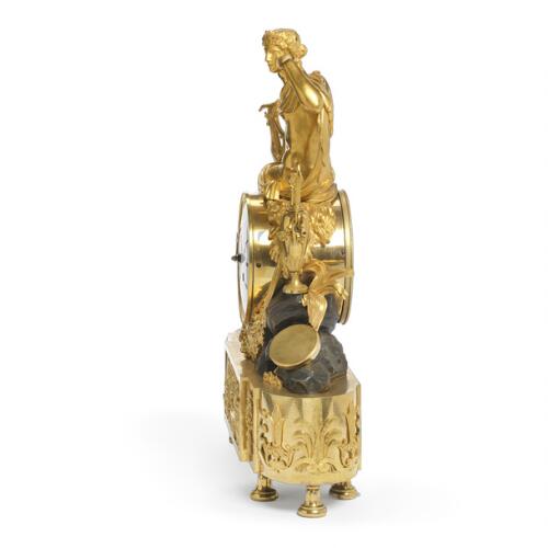 A French Empire gilt and patinated bronze figural mantel clock
