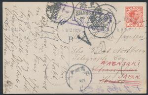 1913. Chr. X, 10 øre, rød. på postkort fra København til Shanghai, China, omadr. til Nagasaki, Japan. Talrige stempler og påtegninger