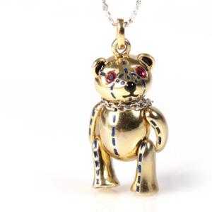 Rubinvedhæng af forgyldt sterling sølv i form af bamse prydet med facetslebne safirer. L. ca. 2 cm. Kæde af sterling sølv medfølger. L. ca. 45 cm. Ca. 2009. 2