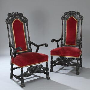 Et par sortmalede armstole rigt prydet med gennembrudte udskæringer i form af blomster og bladværk.  Barok form. 19. årh.  2