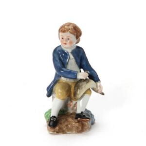 Figur af porcelæn fra serien Elementerne, Vand i form af deng der holder en fisk over sit ene ben. Den kongelige Porcelainsfabrik, ca 1782. H. 9 cm.