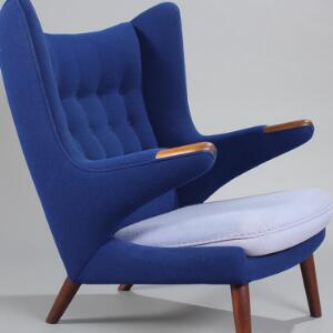 Hans J. Wegner Bamsestol. Øreklapstol med negle og ben af teaktræ, sider og ryg med blåt uld, løs hynde med lavendelfarvet uld. Model AP 19.