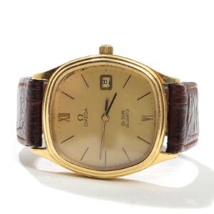 Omega Herrearmbåndsur af 18 kt. guld. Model de Ville. Quartz med dato. Kasse B. 35 mm.