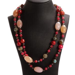 Lang halskæde prydet med perler af facetslebne agater og kvarts i røde og røgfarvede nuancer. Perlediam. ca. 5-25 mm. L. ca. 124 cm.