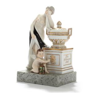 Sørgende kvinde og putto ved urne. Figurgruppe af porcelæn, Kgl. P., dekoreret i overglasurfarver og guld. Juliane Marie mærke. H. 18.