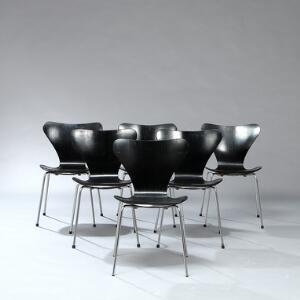 Arne Jacobsen Syveren. Et sæt på seks stole med stel af stål. Sæde og ryg af formbøjet, lamineret sortlakeret træ. Udført hos Fritz Hansen. 6