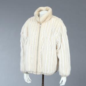 Vendbar minkjakke sat med striber af lys mink, lyst skind og minkkrave. Ca. str. 42. L. ca. 70 cm.