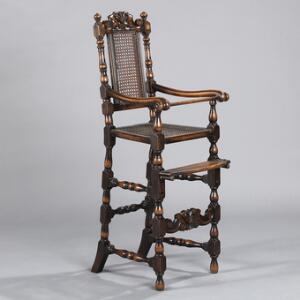 Højstol af bejdset egetræ rigt udskåret med volutter og bladværk, sæde og ryg med flet. 19. årh. H. 107.
