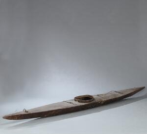 Grønlandsk kajak udført af træ og beklædt med skind. 20. årh. L. ca. 420 cm.
