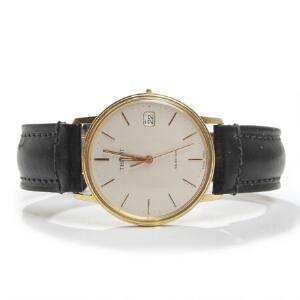 Tissot Herrearmbåndsur af guld. Model Seastar. Lys skive med gyldne visere og timemarkører. Quartz med dato. Kassediam. 34 mm.