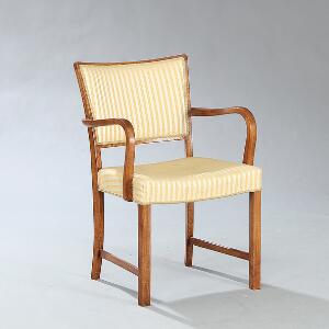Dansk møbeldesign Armstol med stel samt svungne armlæn af bejdset eg. Sæde og ryg betrukket med stribet stof.