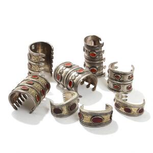 En samling turkmenske Ersari armbånd af delvist forgyldt sølv, prydet med talrige cabochonslebne karneoler. 20. årh. H. 3-9. 8
