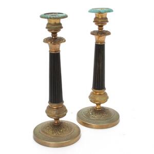 Et par franske lysestager af forgyldt og patineret bronze opsat på runde baser, empire form, 19. årh. H. 29 cm. 2
