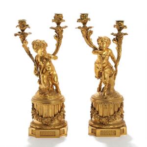 To kandelabre af forgyldt bronze, hver med to lysarme, stamme i form af faun og pige. Louis XVI form. 19. årh. H. 50. 2
