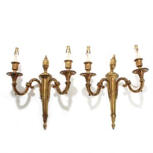 Et par væglampetter af forgyldt bronze, hver med to lysarme. Louis XVI form. 20. årh. H. 45. 2