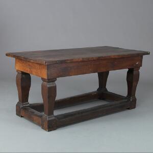 Langbord af egetræ på firkantede stolpeben hvorimellem fodlister. Delvis 18. årh. H. 79. B. 81. L. 170.