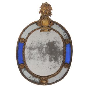 Ovalt barok spejl i Burchard Precht stil, montering af forgyldt bly i form af ansigt og kartouche. Sverige. 18. årh.s begyndelse. H. 41. B. 28.