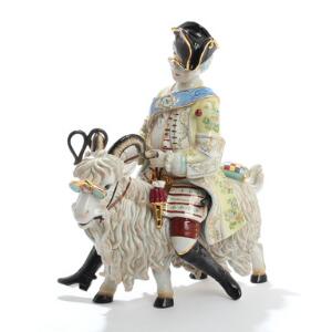 Greve Bruhls skrædder i rococo klæder på gedebuk. Figur af porcelæn dekoreret i farver. Pseudo mærke. 21. årh. H. 41.