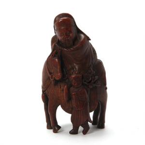 Kinesisk figur af udskåret hardwood i form af vismand ridende på hest med tjener. Sen Qing, ca. 1900. H. 23 cm.