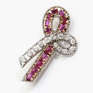 Rubin- og diamantbroche af guld og hvidguld i form af sløjfe prydet med talrige facetslebne rubiner og brillantslebne diamanter med ældre slibning. L. 4,5 cm.