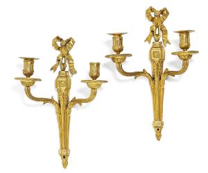 Et par franske Louis XVI lampetter af forgyldt bronze, hver med to lysarme, en lysmanchet mangler. 18. årh.s slutning. H. 36. 2