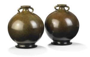 Just Andersen Et par vaser af patineret bronce modelleret med lille munding samt svungne, stiliserede hanke. 2