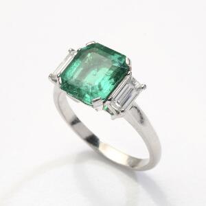 Smaragd- og diamantring af platin prydet med smaragdslebet smaragd på ca. 3.80 ct. flankeret af to smaragdslebne diamanter. Str. 58.
