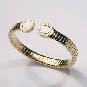 Bvlgari Armring af 18 kt. guld og stål Bvlgari Bvlgari prydet med Bvlgari logo. Diam. ca. 6 cm. Justerbar. Rom, ca. 2009.