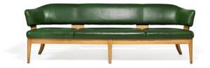 Kaj Gottlob Fritstående fire-personers sofa opsat på seksbenet stel af eg. Sæde samt svævende messingsømbeslået ryg betrukket med grønt skind. L. 240.