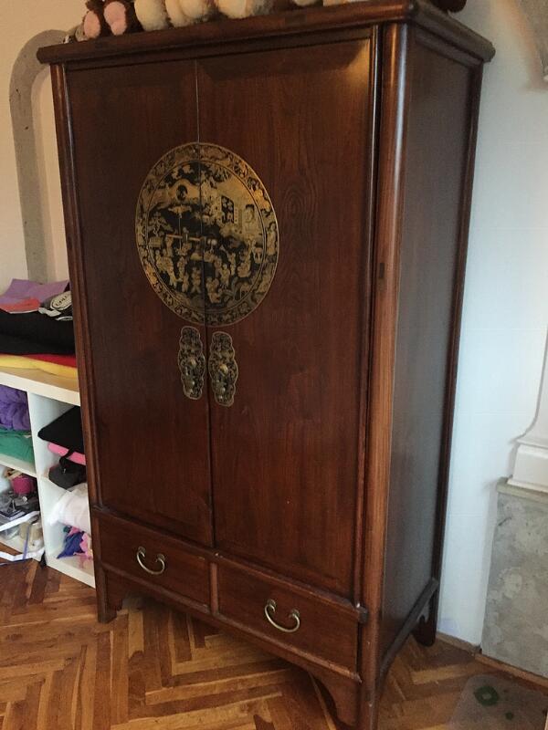 A pair of Chinese dark-polished wooden cabinets, front with two doors and...