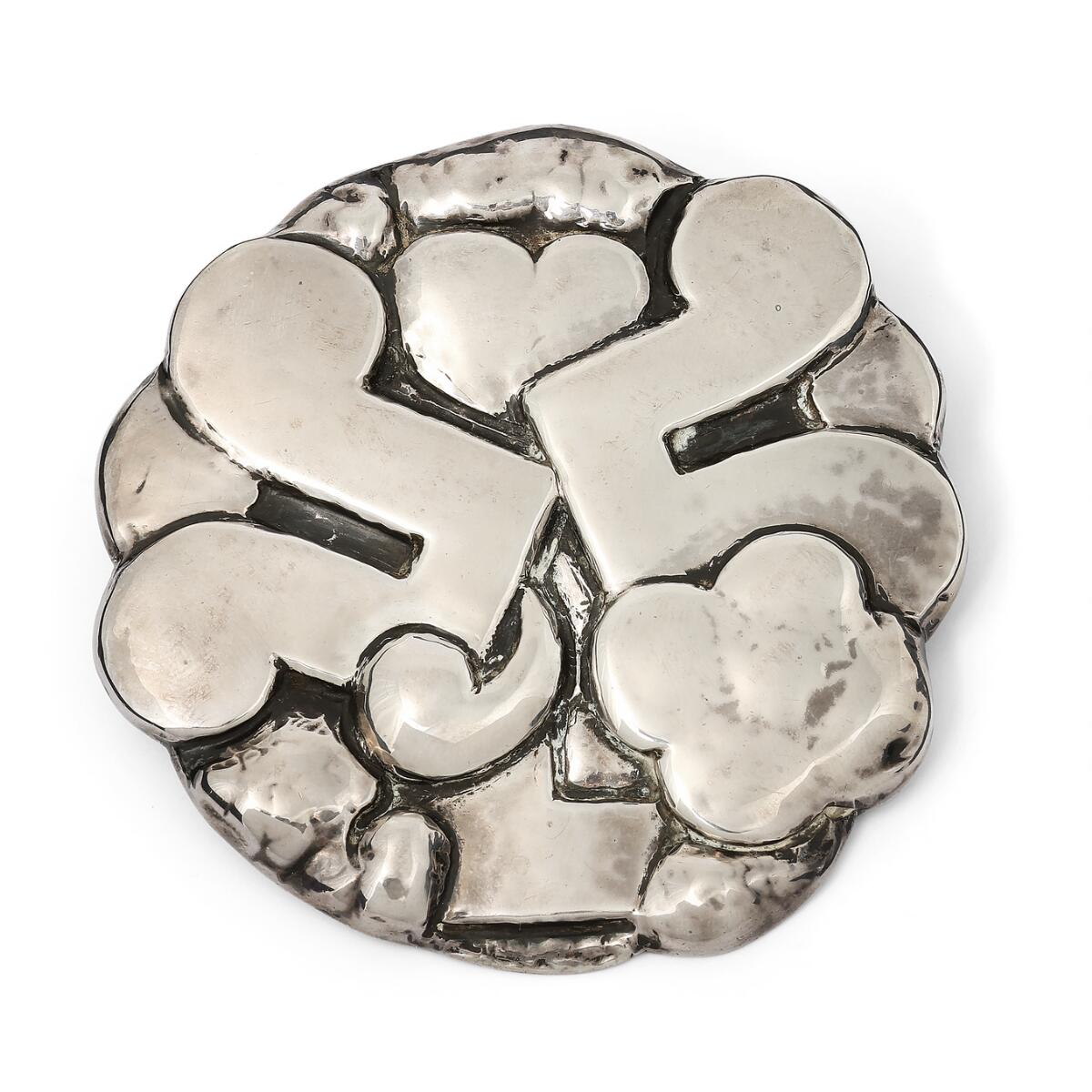 A large, circular silver brooch with stylized ornamantation. Marked monogram for Thorvald Bindesbøll. Made and marked by Holger Kyster, Kolding. Weight 42 g. Diam. 7 cm.