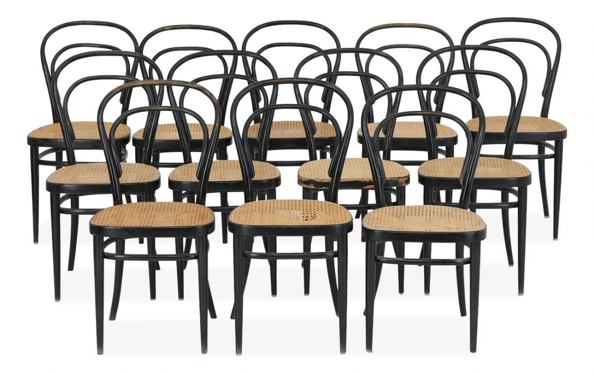 Set of 12 chairs of bentwood black-lacquered beech. Seats fitted with cane. Manufactured by Thonet, some with maker's label. (12)