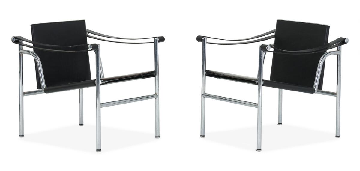 “LC 1”. A pair of easy chairs with frame of chromed steel. Black grain leather upholstery in seat, back and armrest. Manufactured by Cassina. Stamped resp. No. 24872 and No. 24888. (2)
