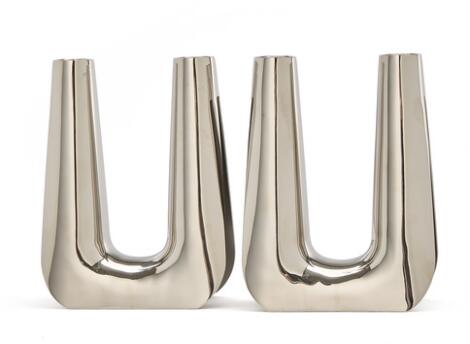 Søren Georg Jensen: A pair of stainless steel candelabra. Smooth, slightly trumpet shaped light arms. (2)