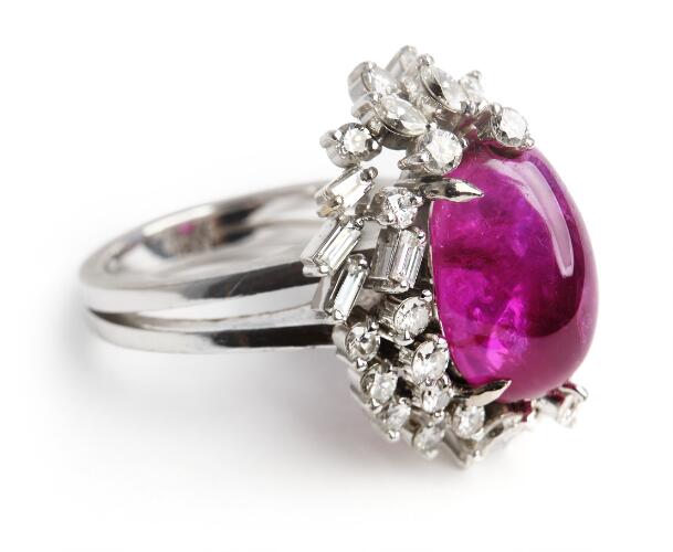 A ruby ring set with a Burma ruby encircled by numerous diamonds ...