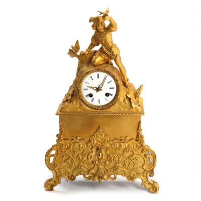 A first part of the 19th century gilt bronze mantle clock, surmounted ...