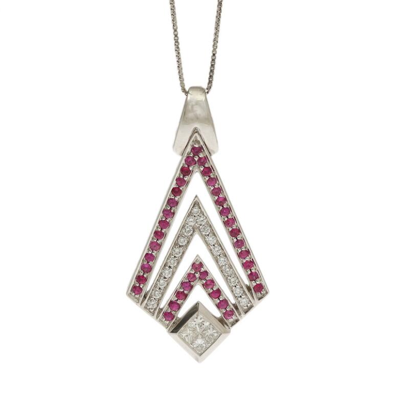 A ruby and diamond pendant set with numerous brilliant-cut diamonds and...