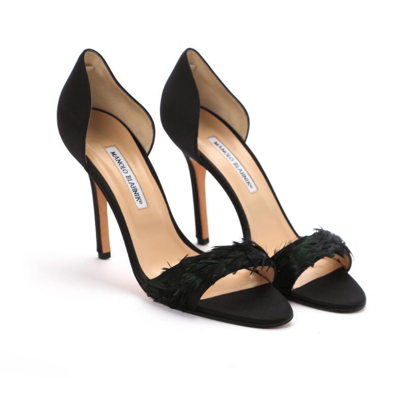 Manolo Blahnik: A pair of stilettos made of black satin with feathers on...