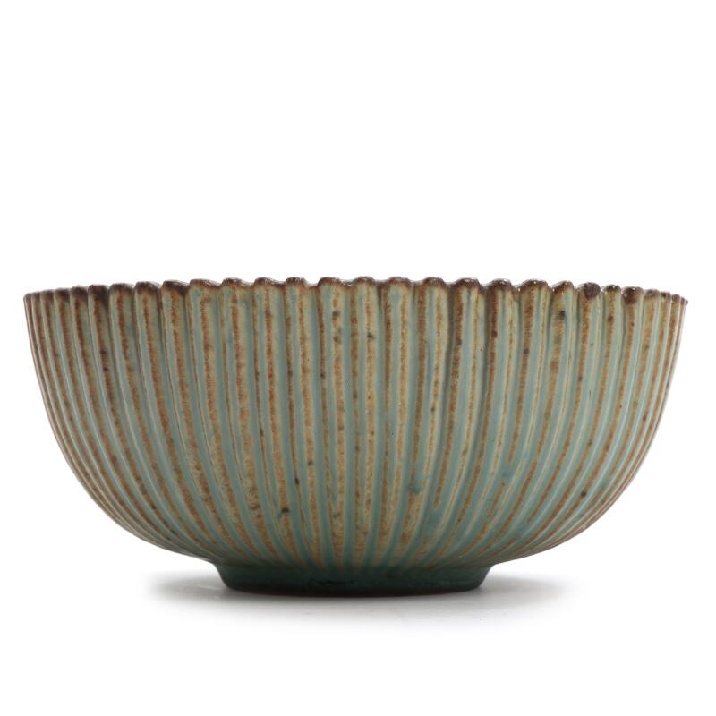 Arne Bang: A stoneware bowl decorated with light green and brownish glaze...
