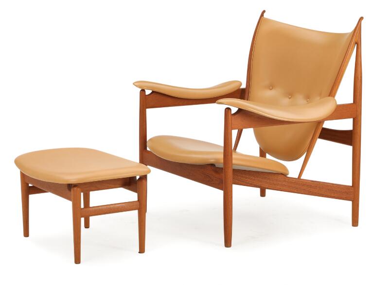 “The Chieftain chair”. A teak easy chair with matching stool. Upholstered...