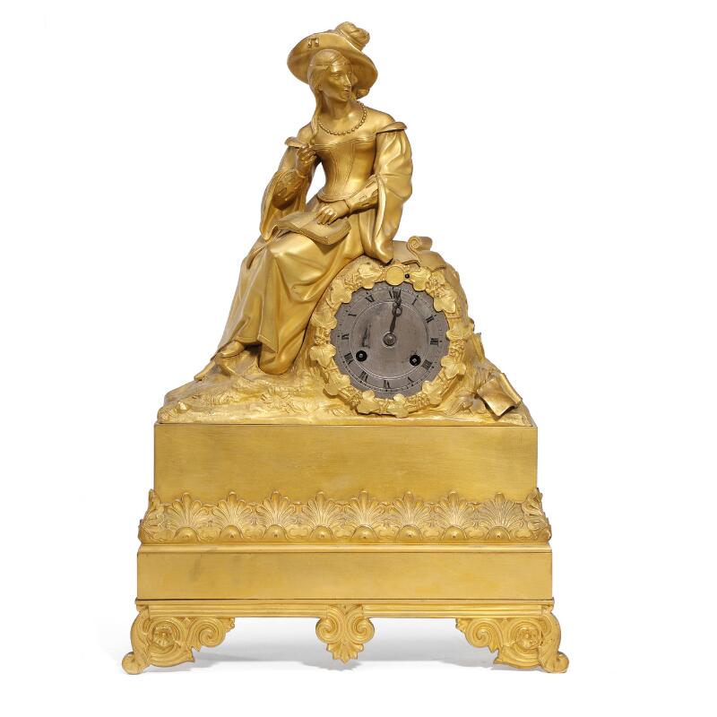 A French late Empire figural table clock of gilt bronze, the case adorned...