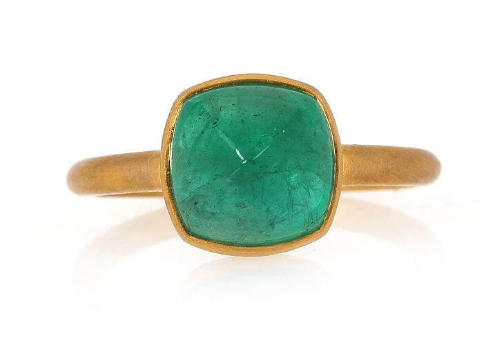 An emerald ring set with a cabochon emerald weighing app. 3.84 ct ...