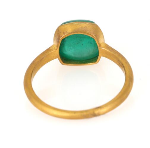 An emerald ring set with a cabochon emerald weighing app. 3.84 ct ...