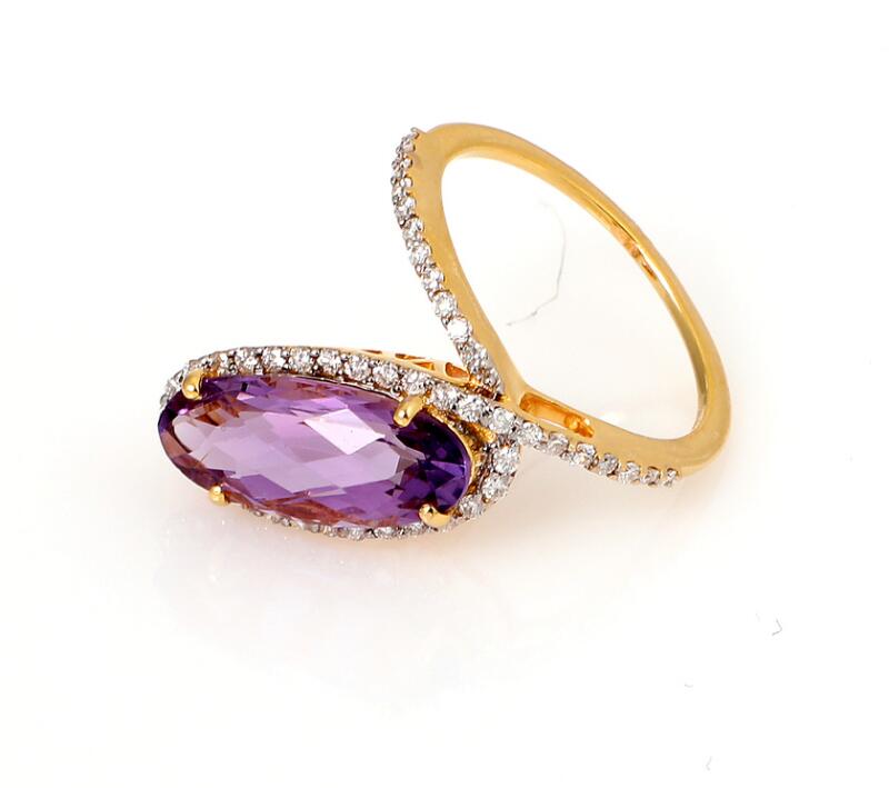 An amethyst and diamond ring set with an oval-cut amethyst weighing app...