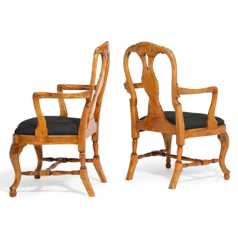A pair of Swedish walnut armchairs, seat upholstered with black