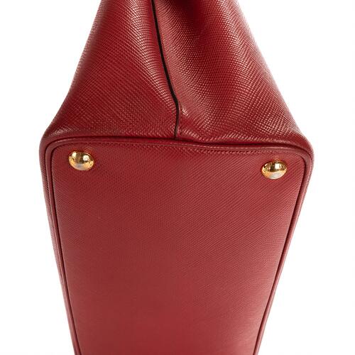 Prada: A bag of dark red Saffiano leather with gold tone hardware