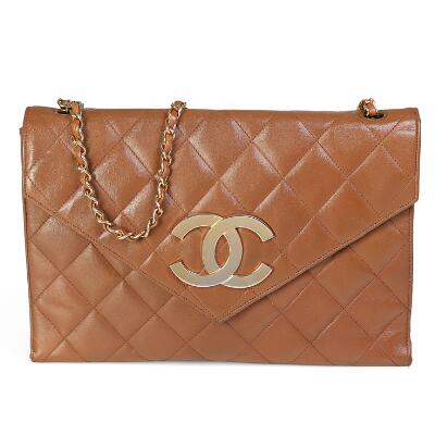 Chanel: A vintage flap bag of brown quilted leather with gold tone