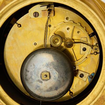 A French Empire mantel clock. Early 19th century. H. 49 cm. W. 38