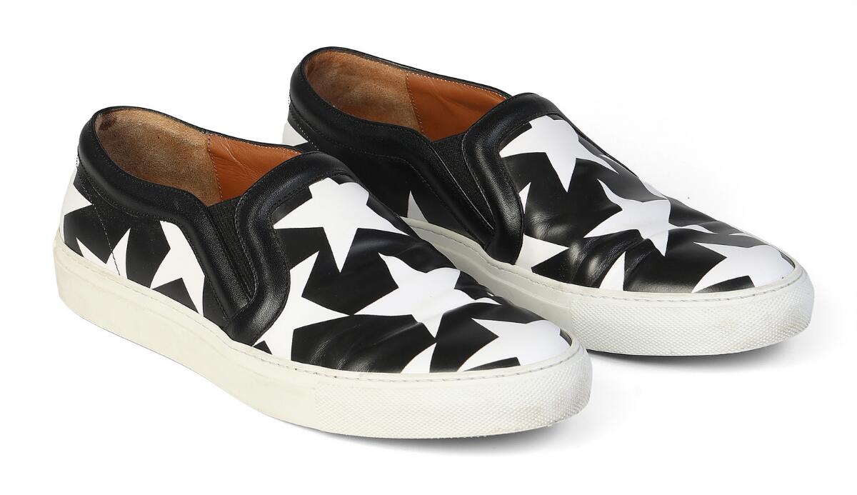 Givenchy: A pair of slip on shoes of white and black leather with